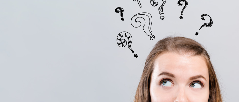 A girl thinking with a bunch of question marks drawn over her head