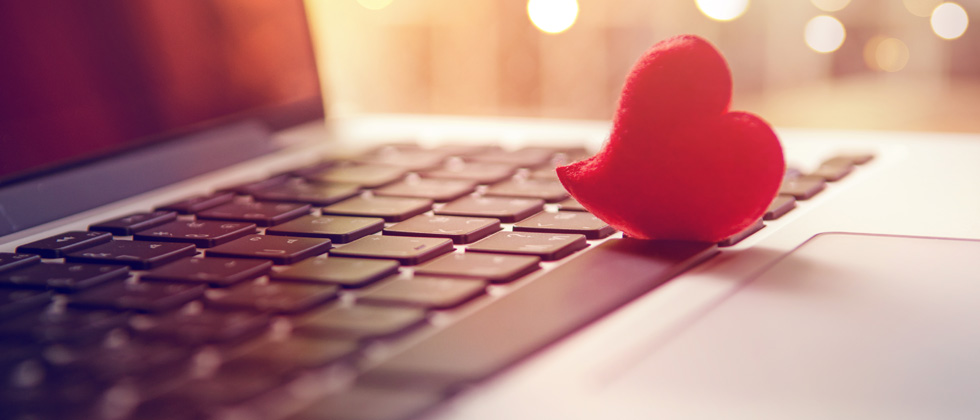 A small cutout heart resting on a keyboard