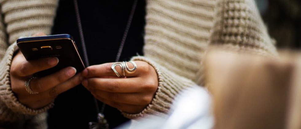 A person nervously holding their phone