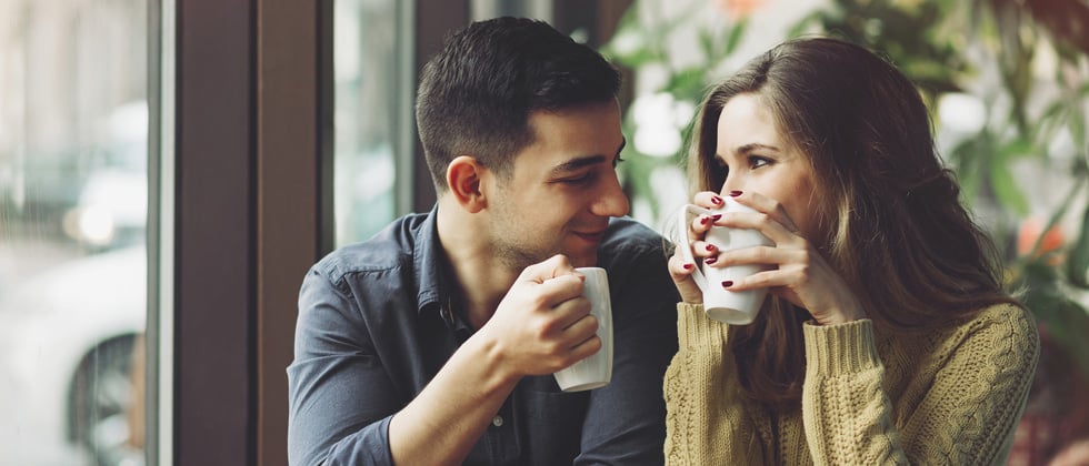 Cute couple having a coffee date gazing into each other's eyes