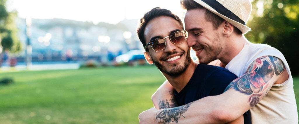 Two men lying in each other's arms as an example of a gay relationship