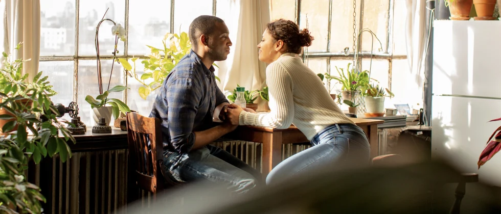 Couple sitting in a café looking each other in the eyes