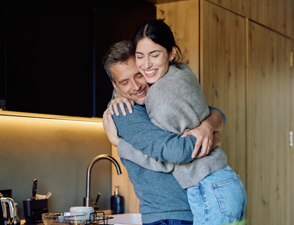 A man and a woman are hugging