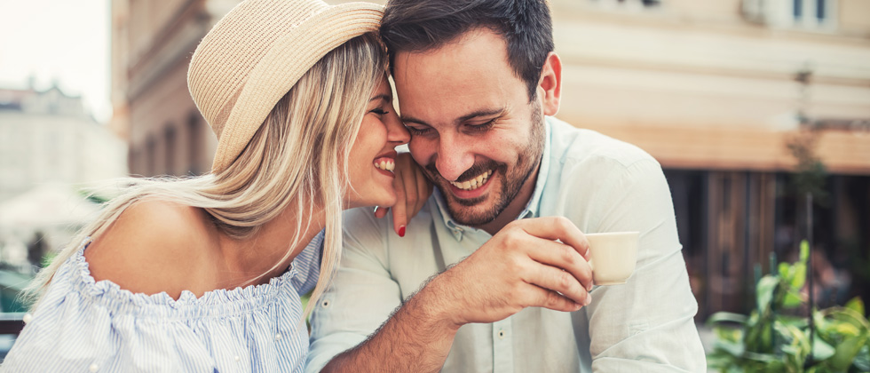 Couple flirting and laughing together on a coffee date