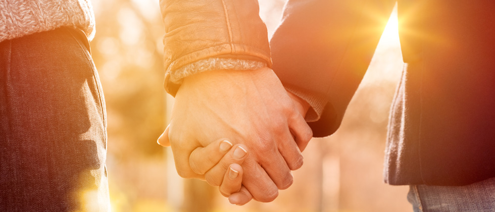 Couple holding hands on a walk together