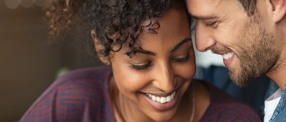 Couple nuzzled together having an intimate conversation