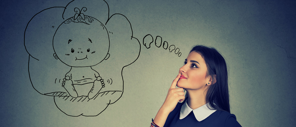 A woman thinking with a bubble over her head with a baby in it