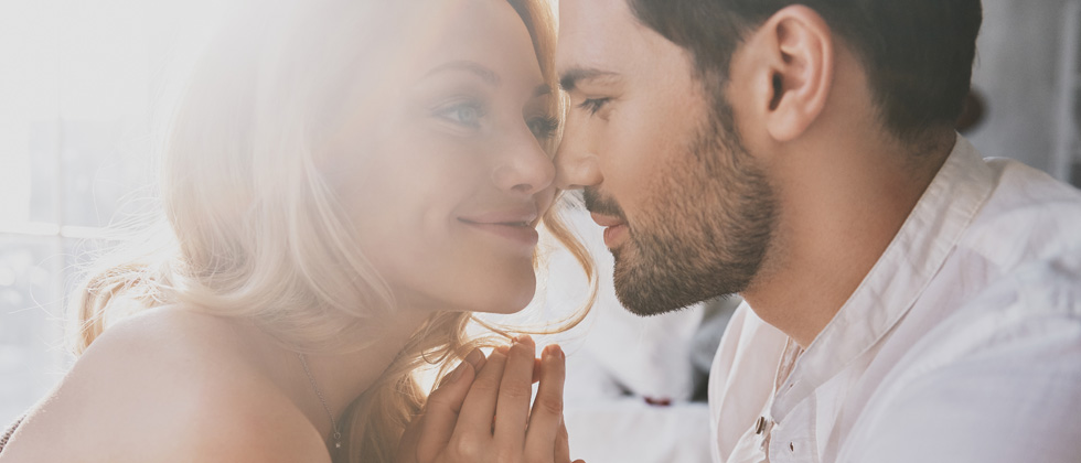 A young couple sharing an intimate moment before they kiss