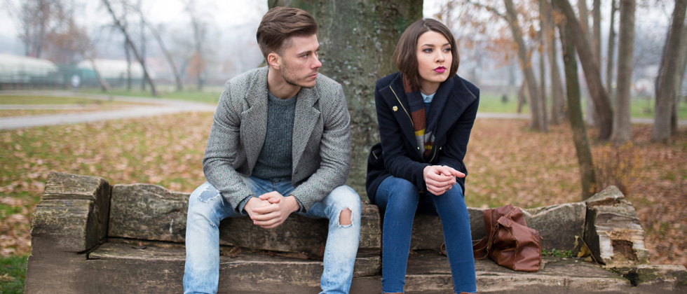 Couple having a difficult decision on a park bench