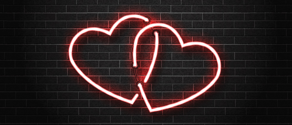 Two interlocked pink heart lights on a wall