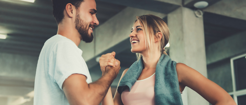 A couple at the gym congratulating each other on their workouts