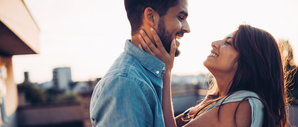 A couple looking at each other lovingly at dusk
