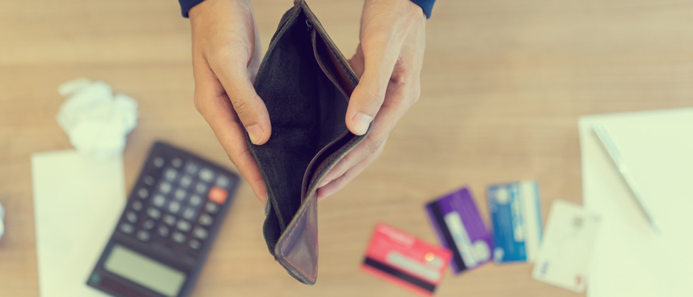 Someone holding up their empty wallet