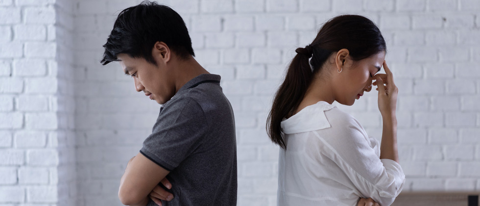 a couple with their backs turned to each other after a fight