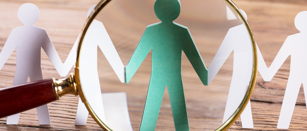 cut out people with a magnify glass over one of them