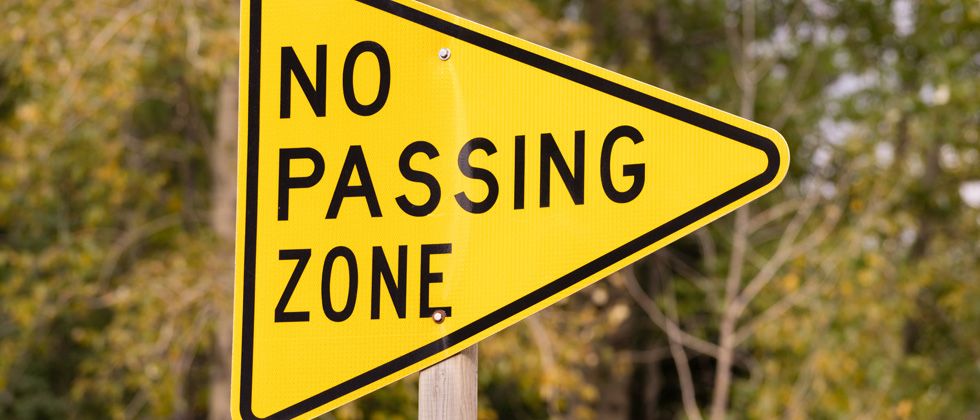 A picture of a sign that says no passing zone