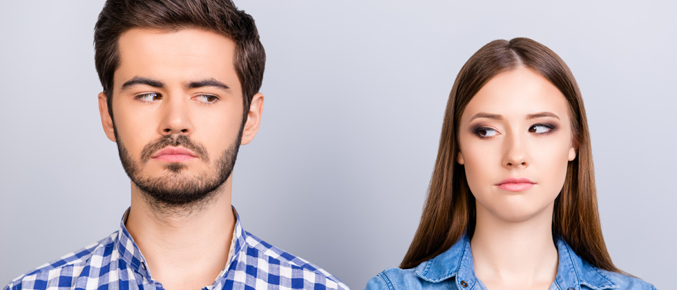 A couple looking at each other through the corners of their eyes