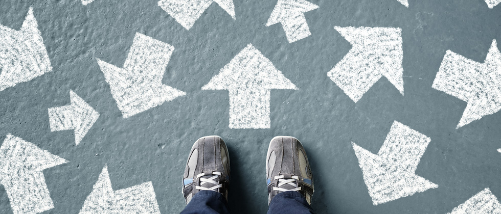 A person standing with arrows pointing in every direction
