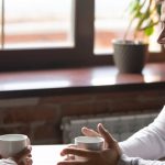 Couple on a first date having a conversation over coffee