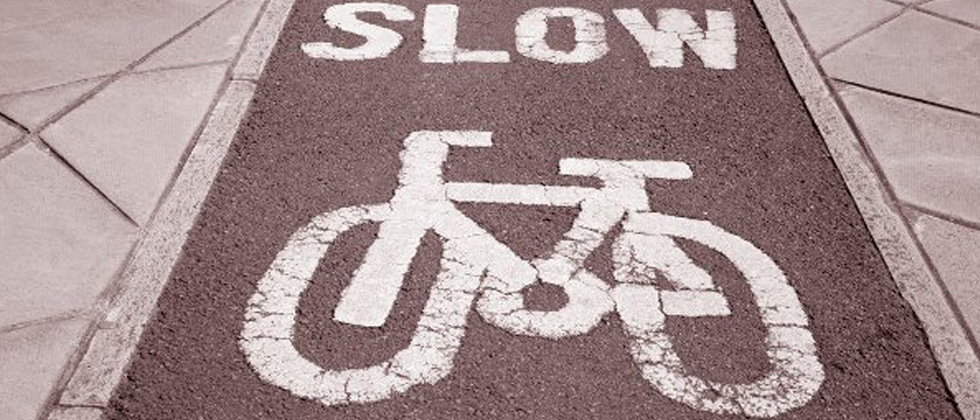 A picture of a bike lane with SLOW written across it