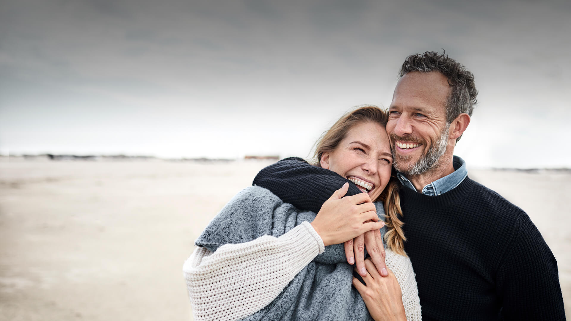 40s dating symbolized by a man who strolls happily with his date at the beach in Canada