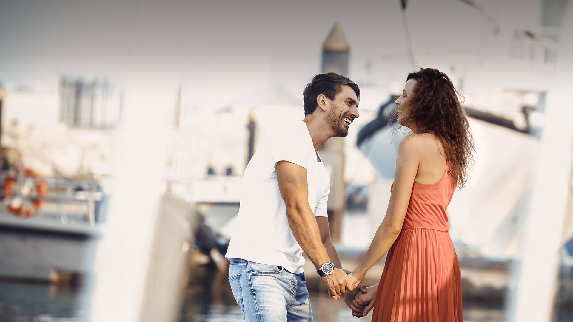 Arab dating symbolized by a man and woman holding hands and standing happily at the port in Canada