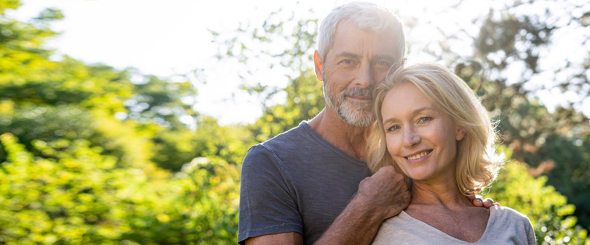 Dating over 60s symbolized by a couple smiling into the camera