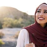 Woman looking happily at camera, symbolizing Muslim dating