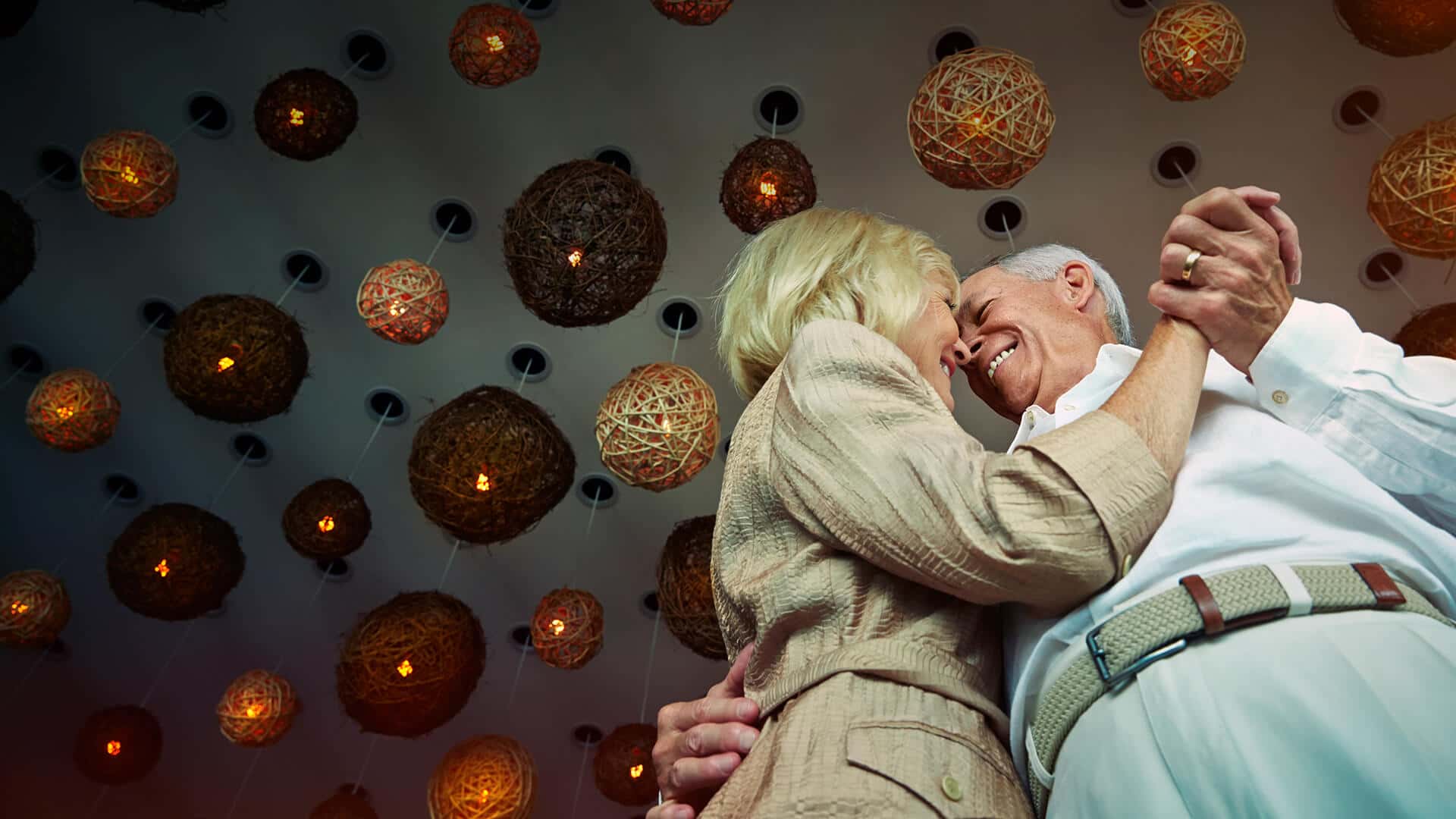 Senior dating symbolized by a couple that is dancing happily in love in a romantic atmopshere in Canada