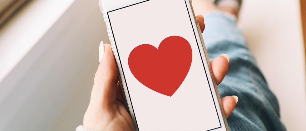 An iphone with a big heart pictured on the screen