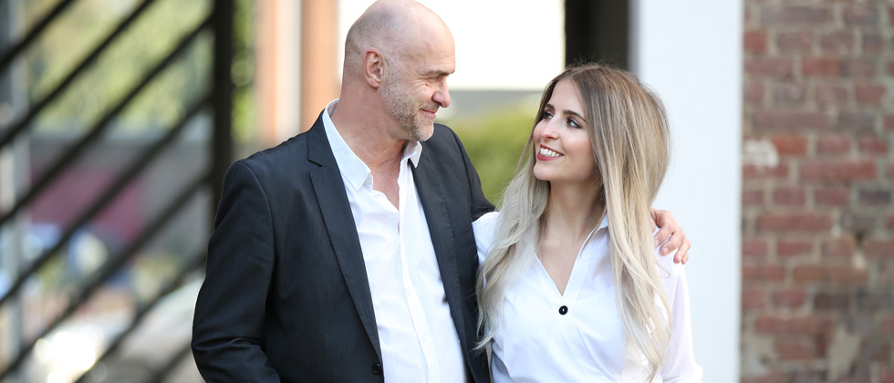 Older man & younger woman staring lovingly at each other