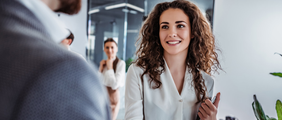 Young professional woman smiling while having a conversation