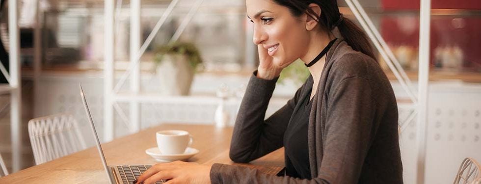 safety tips illustrated by a woman sitting in front of her laptop