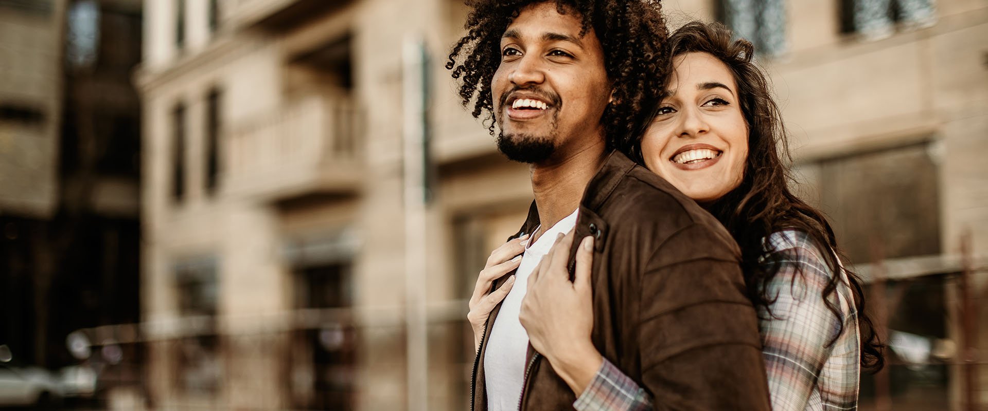 Woman hugging man from behind as a symbol of how to find the right person