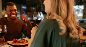 A man and a woman enjoying dinner together in a restaurant.