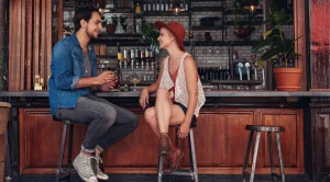 A couple enjoying a date in a pub.