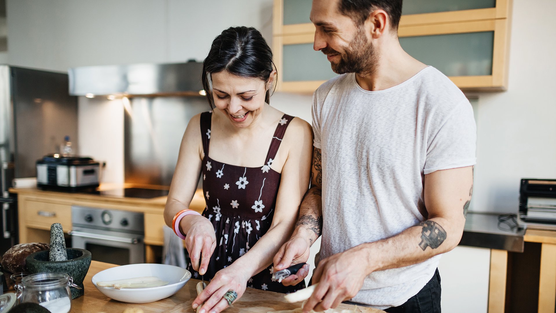 Young couple who is cooking together and having fun while doing so.