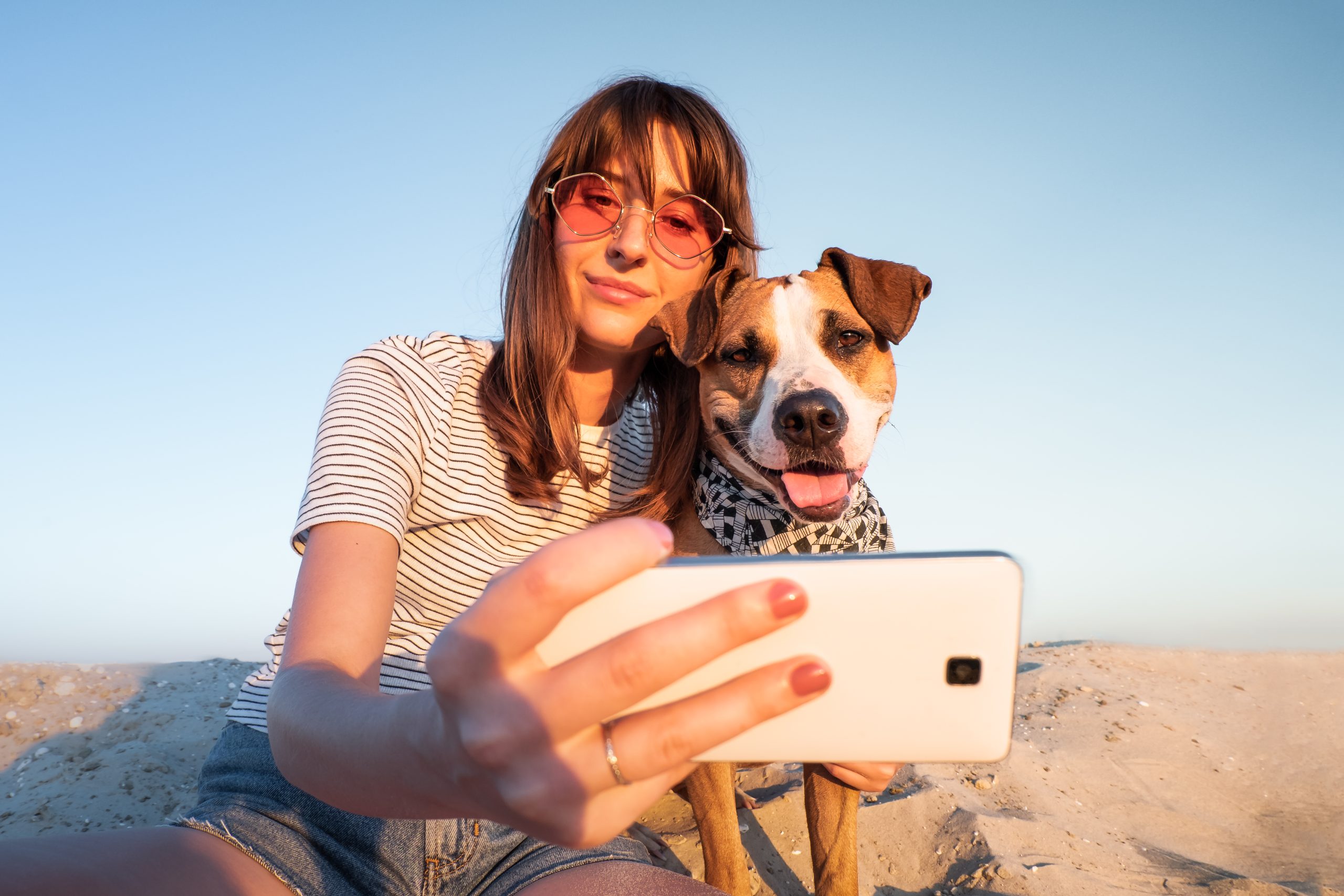 Single Woman taking a selfie with her dog