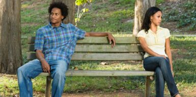 Man sits on bench facing away from woman as sign that he is not into you