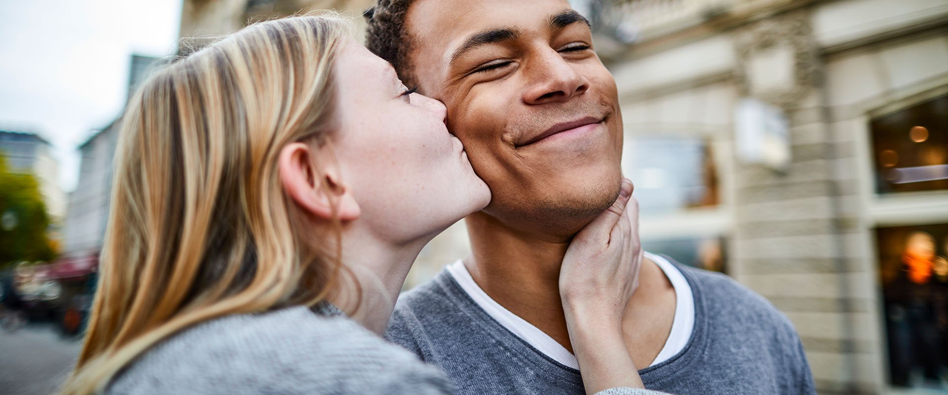 Woman kisses man on the cheek as a symbol of how to kiss well