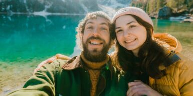 Man and woman smile in camera as an example of compatibility in a relationship