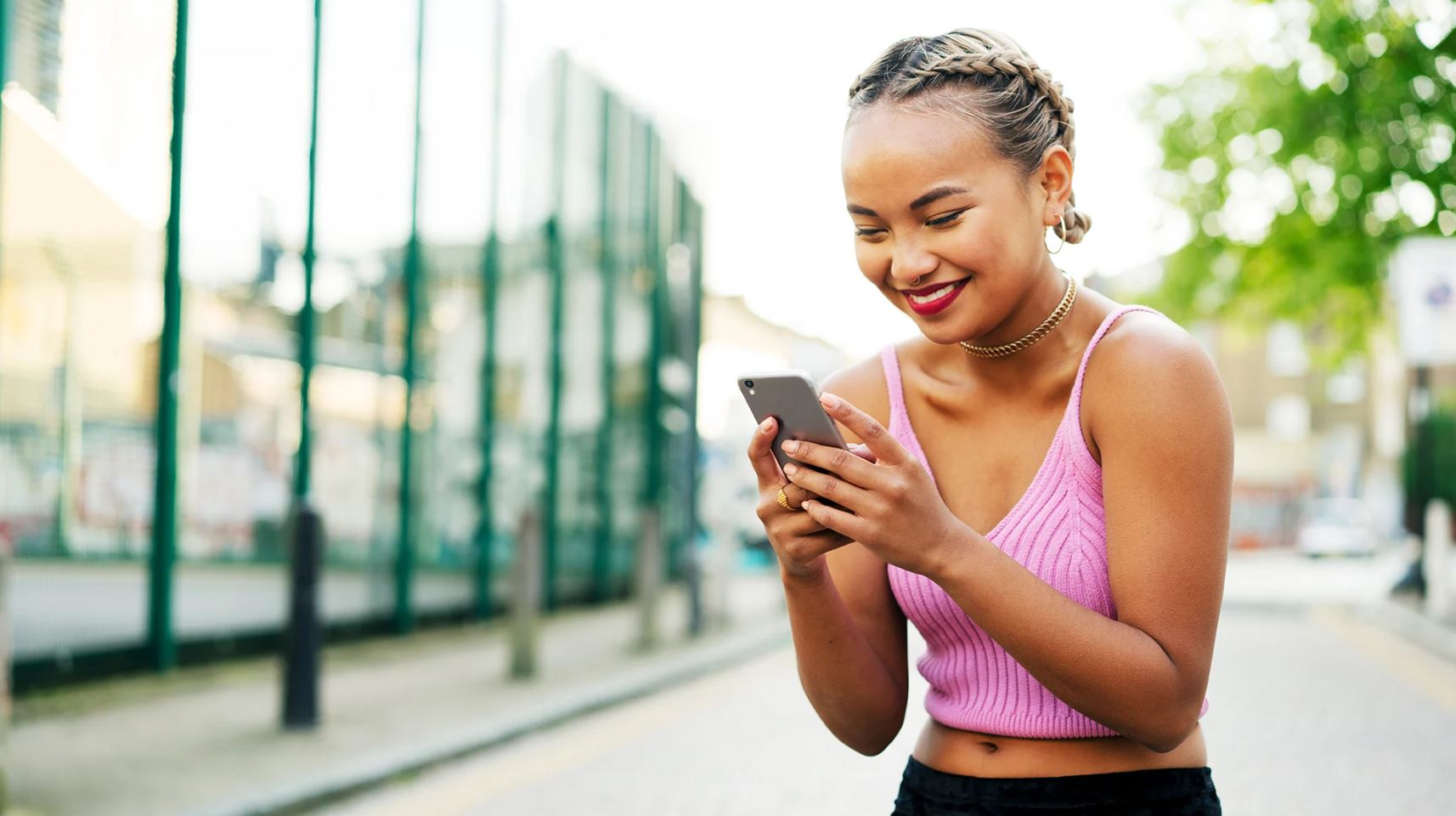 Woman with phone in her hands smiling