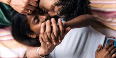 Man and woman lying close together with hands crossed as a symbol of how dou you know if someone loves you