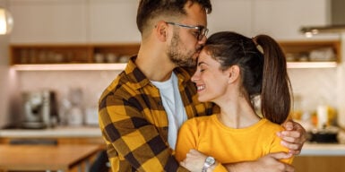 Man holding woman in his arms as a symbol of how to be a good boyfriend