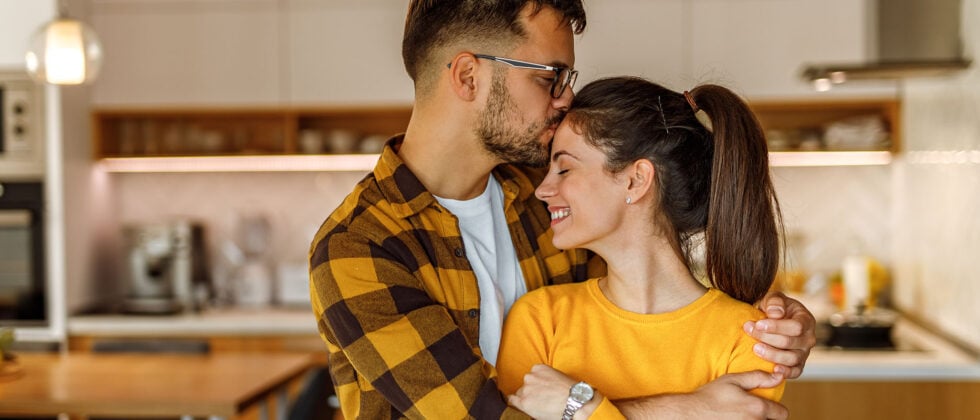Man holding woman in his arms as a symbol of how to be a good boyfriend