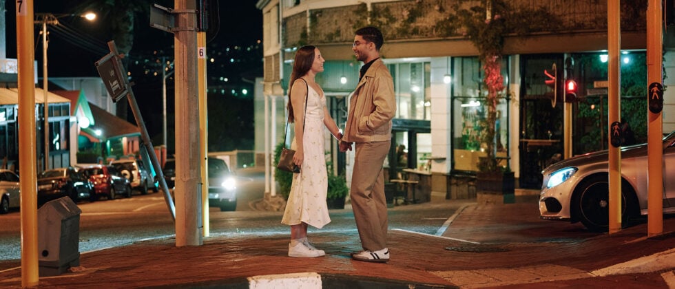 Man and woman standing holding hands on the street as a symbol of how to start dating