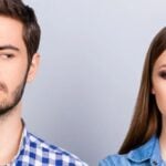 Man and woman look at each other thoughtfully from the side and think: "we have nothing in common".