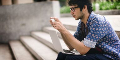 Man sitting on stairs with laptop and cell phone as symbol why ghosters always come back