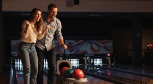 A couple enjoying a bowling match on a date.