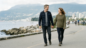 A couple walking hand in hand at the seawall in kitsilano, vancouver.